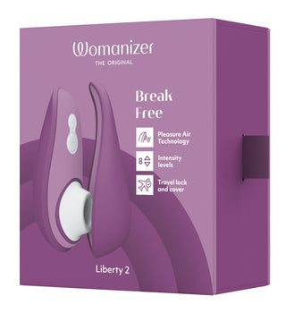 Womanizer Liberty 2 Luftvibrators lila låda visar produktbilden och funktioner som "Pleasure Air Technology", "8 Intensity Levels", ett reselås och ett lock.