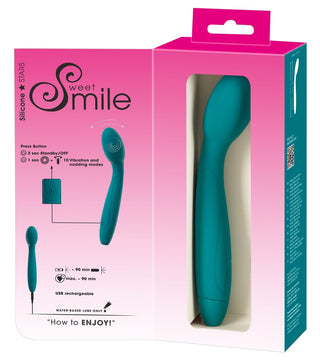 Vibrator med Nickande Huvud - teal silikon, vattentät sexleksak i rosa och vit förpackning. Produktfunktioner och instruktioner synliga; utformad för effektiv G-punkt stimulans.