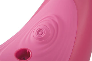 Närbild av Vibepad RIDE ON i rosa, som visar den cirkulära räfflade ytan och en liten rund öppning längst ned till vänster, vilket återspeglar designen för handsfree-stimulator.