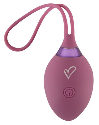 Rosa, oval fjärrstyrd kegelboll med hjärtdesign, synlig strömknapp och ett flexibelt handtag med ögla.