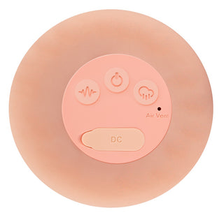 Realistixxx RealMasturbator Lösvagina är en cirkulär, persikofärgad Natureskin-enhet med tre knappar, en DC-port märkt Air Vent och erbjuder vibrations- och sugfunktioner för en realistisk masturbatorupplevelse.