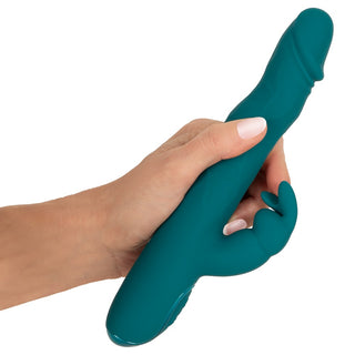 En turkosfärgad silikonvibrator av typen rabbit med böjd skaft och extern stimulator, avbildad mot en enfärgad bakgrund.