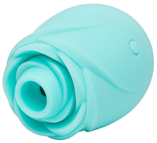 Turkos ROMP Rose Glow klitorisstimulator med slät yta och ergonomisk design, visas på en vit bakgrund.