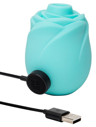 ROMP Rose Glow Klitorisstimulator i blå silikon med USB-laddningsport och kompakt, ergonomisk design.