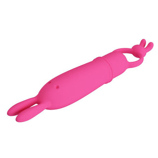 Rosa bulletvibrator i silikon med kaninöronspets och ringhandtag, mot en vit bakgrund.