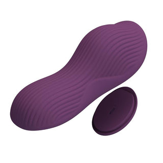Lila silikonvibrator med textur och en rund fjärrkontroll, båda på en vit bakgrund.