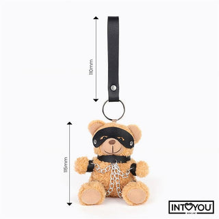 Bubu BDSM Teddy Nyckelring är en nyckelring i form av en nallebjörn i plysch med svart mask, manschetter och kedjor i veganläder, visas med mått.