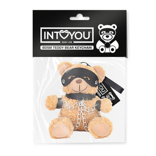 Bubu BDSM Teddy Nyckelring: denna nyckelring har en maskerad teddy med kedjor, tillverkad i veganskt läder och levereras under INTOYOU-märket - ett lekfullt tillskott till dina vardagsprylar.