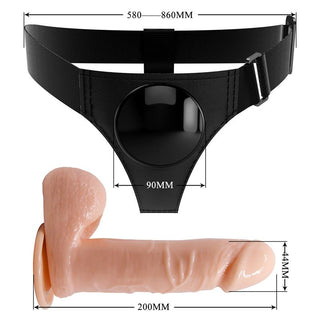 Svart axelbandslös strap-on i slätt material med justerbar sele.
