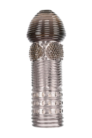 Selopa Penissleeve Set visar upp ett texturerat glasobjekt med en rundad topp, med räfflade och prickade mönster, vilket skapar en elegant siluett på en vit bakgrund.