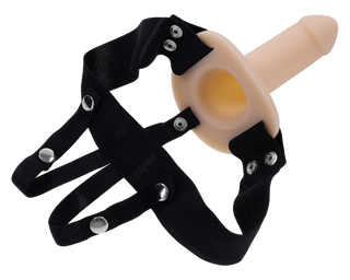 Beige ihålig strap-on med svart justerbar sele och metallknäppen, tillverkad av syntetmaterial, visas på vit bakgrund.