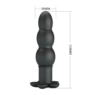 Svart analplugg i mjuk silikon, tre rundade segment, vibratorfunktion, cirka 11 cm hög och 3 cm bred.