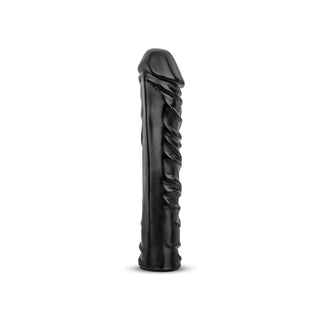 Realistisk XXL Dildo 33 cm är en svart, cylindrisk silikondildo med en naturtrogna konsistens, designad för intensiv njutning och visas upprätt mot en vit bakgrund.