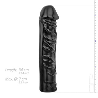 Realistisk XXL Dildo 33 cm, i djupsvart, står upprätt bredvid måtten som visar dess imponerande storlek – perfekt för extrem njutning och intensiv stimulans.