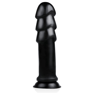BUTTR MadBull Muzzl XXL Dildo, ett svart spiralstrukturerat silikonobjekt tillverkat av kroppssäkert-material, står upprätt med en utsvängd bas mot en vit bakgrund.