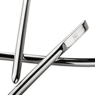 Närbild av snygga stolsben i polerad metall som korsar varandra, med en logotyp ingraverad på ena, som påminner om den fint utformade designen hos Sinner Gear Dilator Set 4-pack.