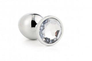 Gleaming Love Silver Plug S, ett kompakt metallföremål med en juvelliknande spets, glänser när den framhäver sin ergonomiska design på en vit bakgrund.