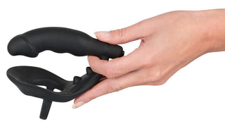 En hand håller Black Velvets Penisring & Buttplug mot en vit bakgrund.