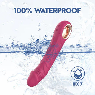Rosa silikon dildo vibrator nedsänkt i vatten, slät design, IPX7 vattentät text synlig på bilden.