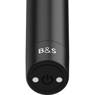 Närbild av den eleganta, cylindriska Black&Silver Kernex 2, med B&S-text och en strömknapp, som framhäver dess diskreta och uppladdningsbara design.