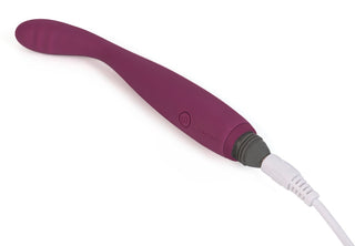 Svakom Cici är en diskret designad lila uppladdningsbar personlig massageapparat med en elegant vit laddningskabel.