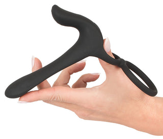 Hand som håller Penisring Couples Vibrator, en ergonomisk svart enhet med ett öglehandtag designat för komfort och mångsidighet.