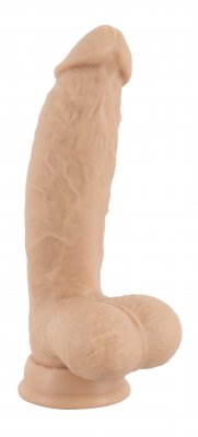 Realistixxx Torero Dildo är en beige realistisk dildo med texturerade detaljer och en bifogad sugpropp för extra stabilitet, stående upprätt.