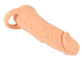2in1Extension + Masturbator har en persikofärgad, realistisk Nature Skin-hylsa med en texturerad utsida och ögla för säker fastsättning, vilket erbjuder ökad mångsidighet och en autentisk upplevelse.