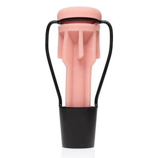 Fleshlight Torkställning är en rosa och svart enhet med cylindrisk form och handtag, som liknar en diskret Fleshlight.