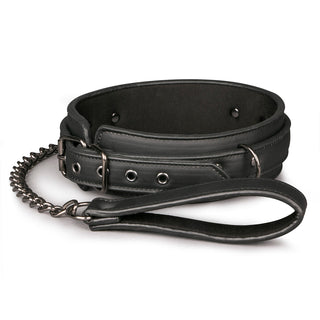 Bdsm Halsband Med Koppel, bondagekrage i svart läder med kedja och handtag på vit botten.