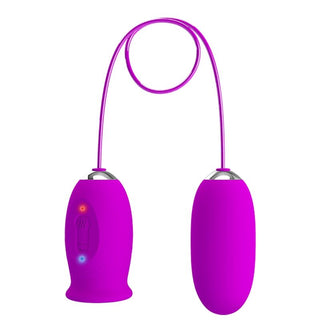 Daisy Dual Egg Vibrator är en rosa trådlös vibrator med anslutningskabel, som visas mot en vit bakgrund.