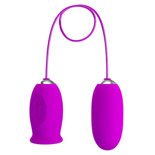 Daisy Dual Egg Vibrator är en lila trådlös enhet med en anslutningskabel, som visas mot en vit bakgrund.
