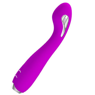 Lilla buet vibrator med E-stim-funktion och metallisk detalj, tillverkad av glatt material, fotograferad mot vit bakgrund.