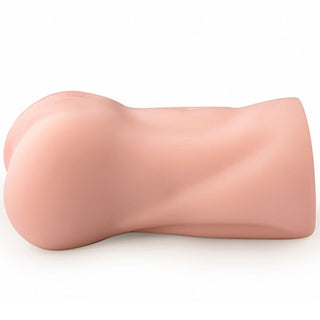 En vaginal masturbator i silikon i en mjuk rosa färg med en böjd, texturerad utsida, visas på sidan.
