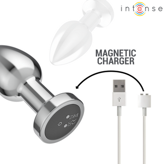 Intense Vibrerande Analplugg M i metall med magnetisk laddningsbas och USB-kabel; "MAGNETIC CHARGER" text samt pil mellan produkterna.