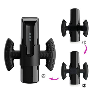 Svart cylindrisk masturbator med sidohandtag, LED-display och synliga sömmar som tyder på en tredelad monteringsdesign.