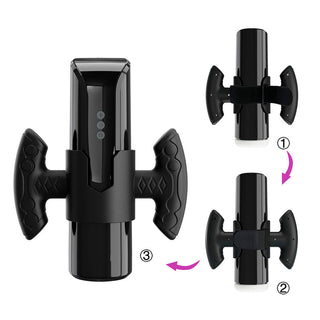 Svart cylindrisk masturbator med sidohandtag, LED-display och synliga sömmar som tyder på en tredelad monteringsdesign.