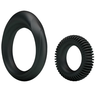 Två svarta penisringar av silikon: en slät oval ring och en mindre räfflad ring.