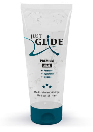 Det klara "Just Glide Premium"-röret, märkt som ett silikonbaserat glidmedel, utlovar en lyxig intim upplevelse. Dess förpackning har blå accenter och framhäver nyckelingredienser: Panthenol, Hyaluronan och Silikon, med tre stjärnor som indikerar kvalitet för optimal komfort.