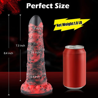 En glöd-i-mörkret texturerad artikel, liknande Monster G-punktsdildo, som visas bredvid en läskburk för storleksreferens.