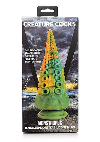 Box av en Monstropus Tentacled Silikon Dildo, som visar upp en tentakeldesign mot en stormig bakgrund.