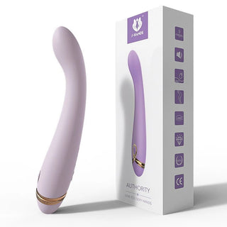 Ljuslila silikon G-Punkt Vibrator Kom-Hit Rörelse med böjd design, visas upprätt bredvid sin märkesförpackning.