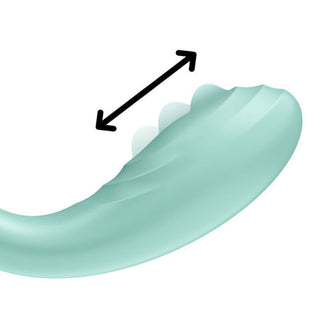 En grön dental aligner med en dubbelhövdad pil symboliserar flexibilitet, ungefär som den anpassningsbara designen hos Satisfyer Rrrolling Pleasure Vibrator.