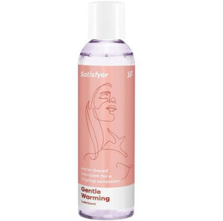 Flaska Satisfyer Gentle Warming Glidmedel med en rosa etikett som visar en abstrakt ansiktskontur.