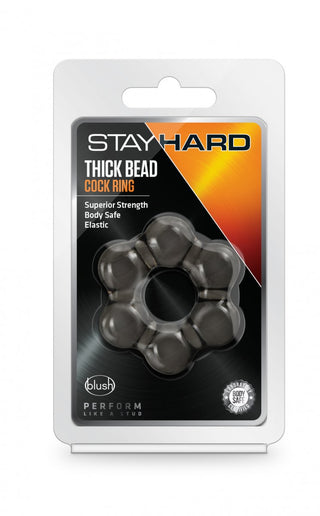 Stayhard Thick Penisring har svarta pärlor på en orange-svart bakgrund, vilket ger extra stimulans.
